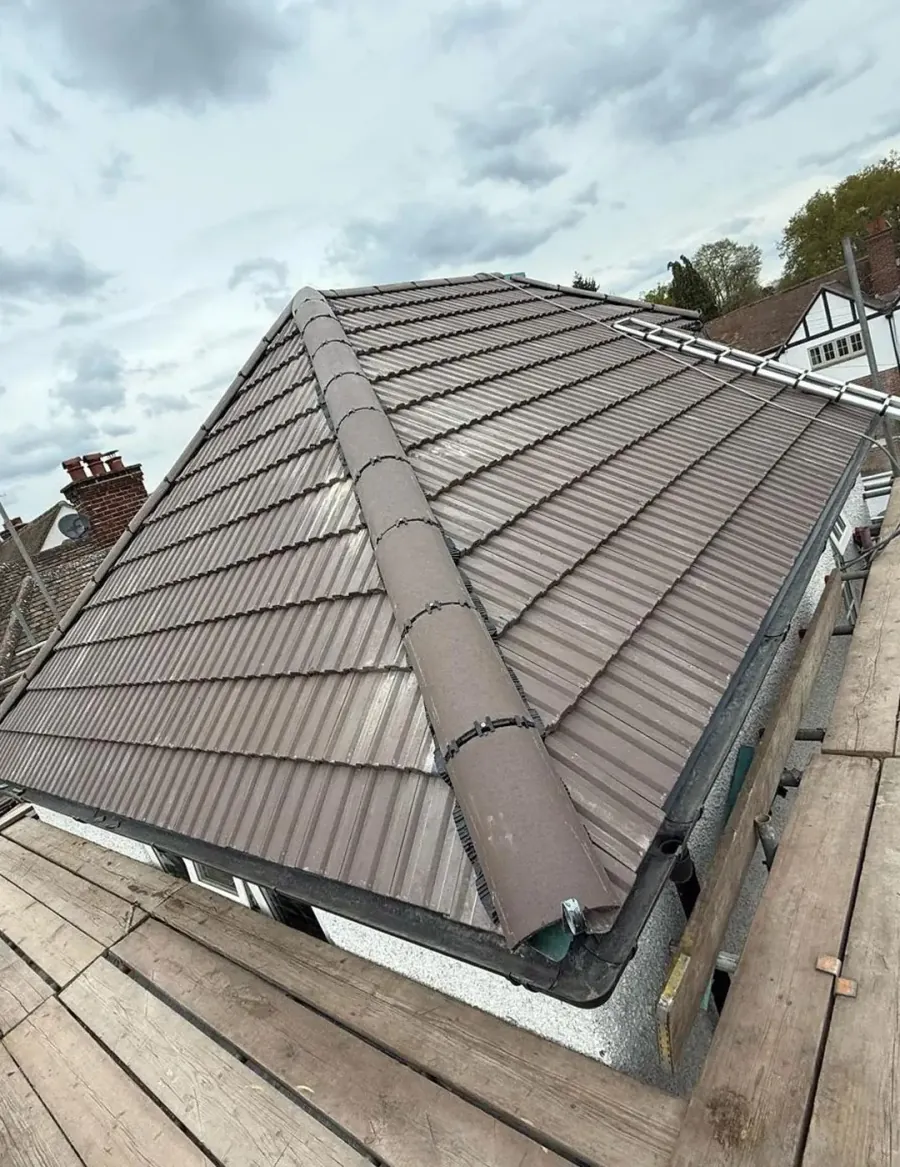 Roofer fitting new tiles during a roof replacement in Surrey