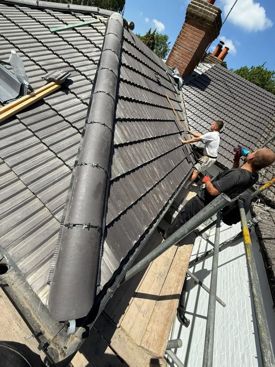 Roofer tracing the source of a roof leak on a Frimley property