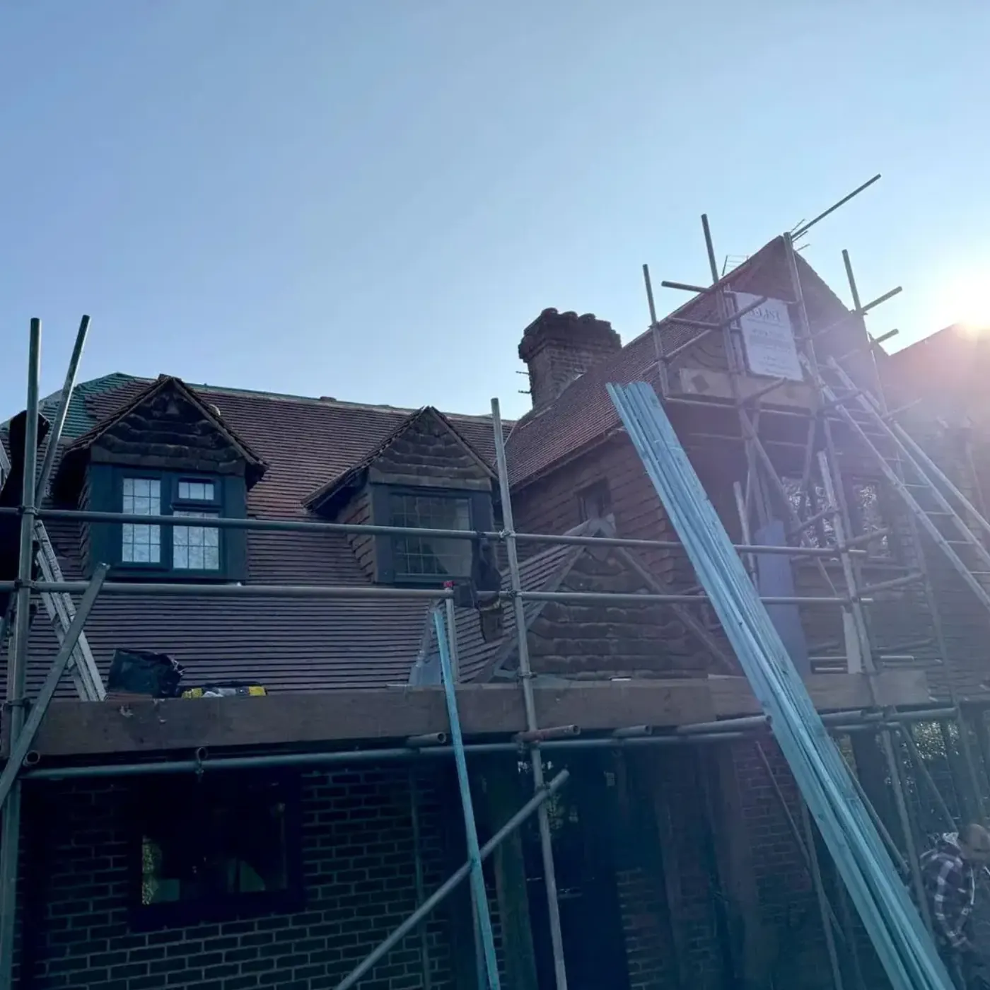 Roofer working on a tiled roof in Frimley, Surrey
